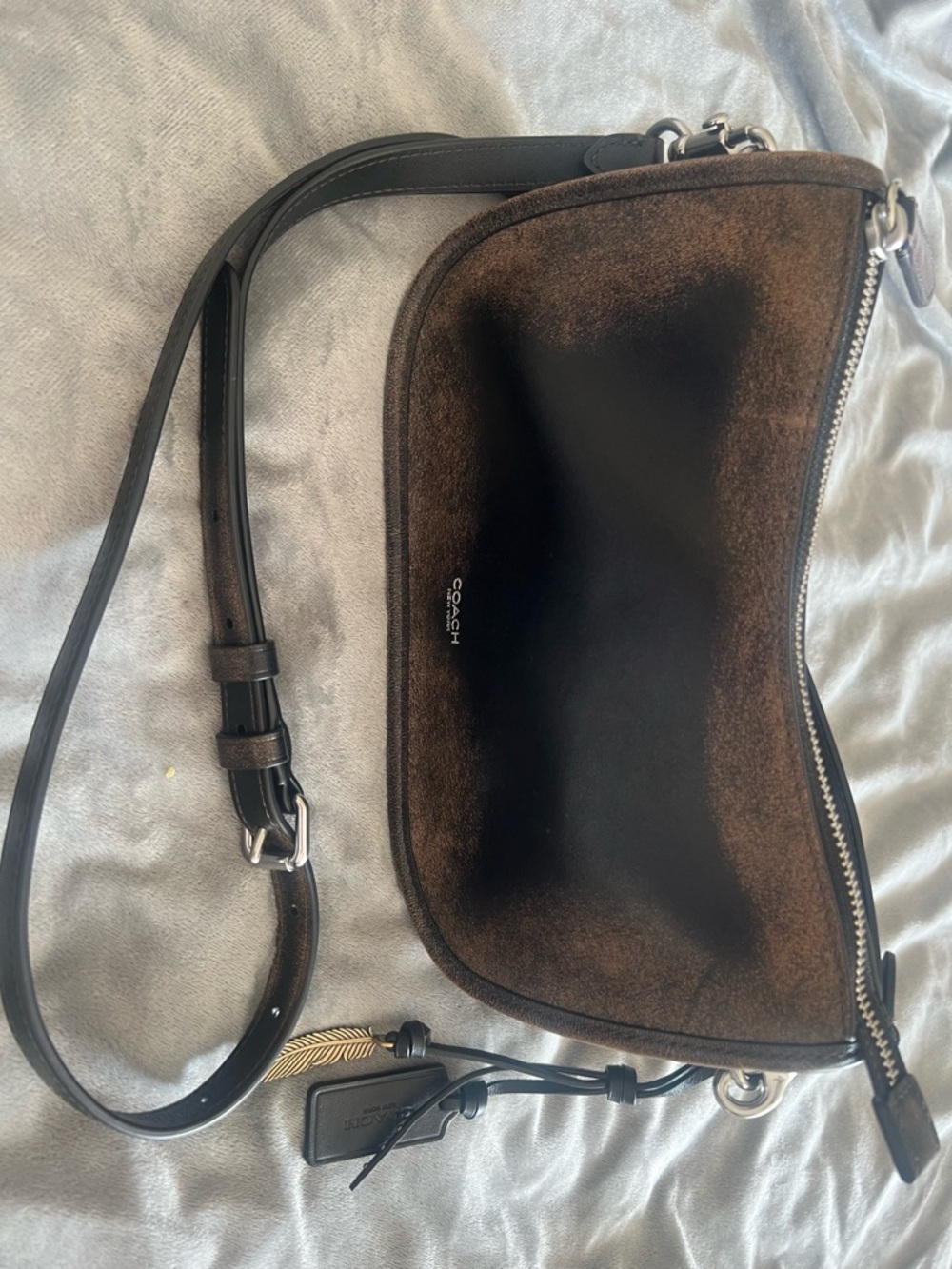 Coach loved leather crossbody bag with charms. Only used a couple times.